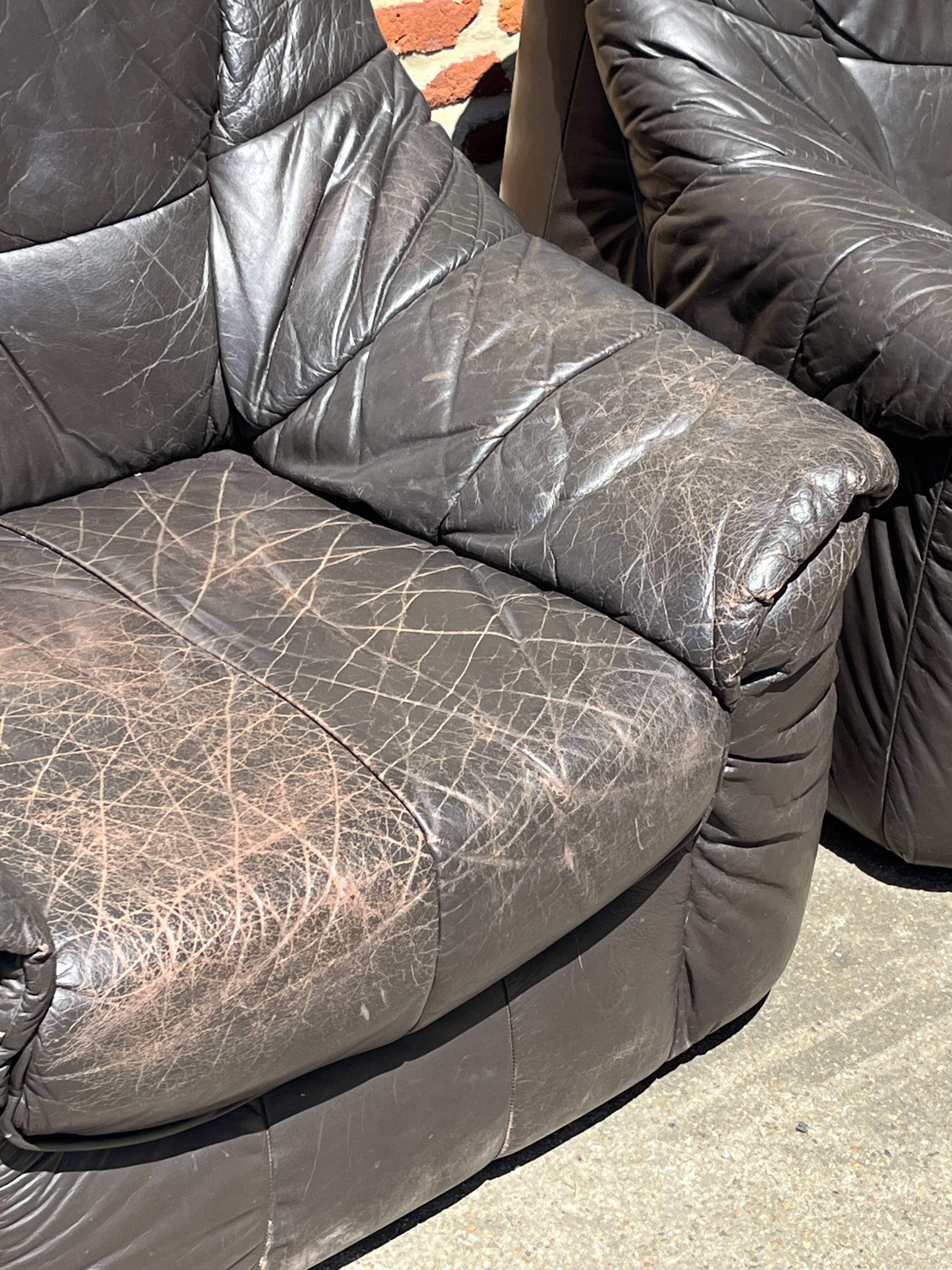 Pair of patinated leather club armchairs