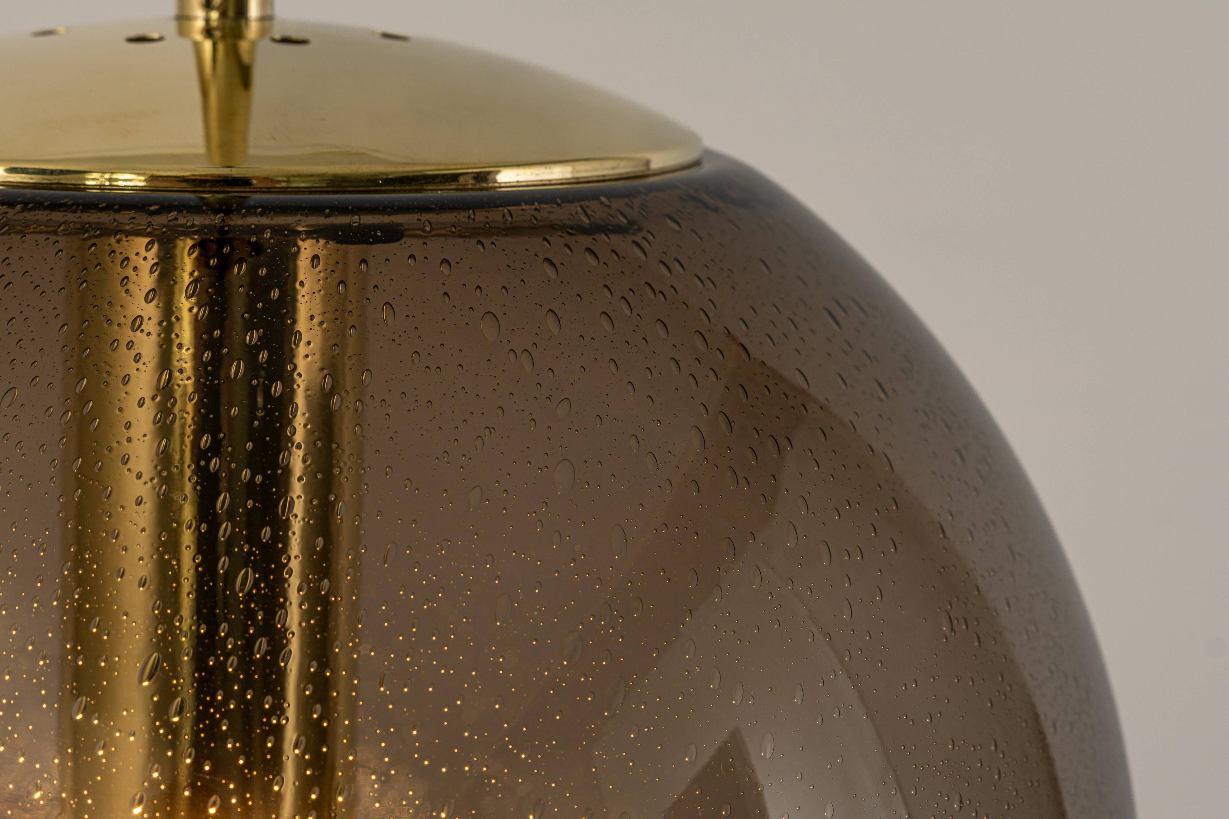 Large smoked glass ball pendant by Limburg in brass, Germany, 1970s.