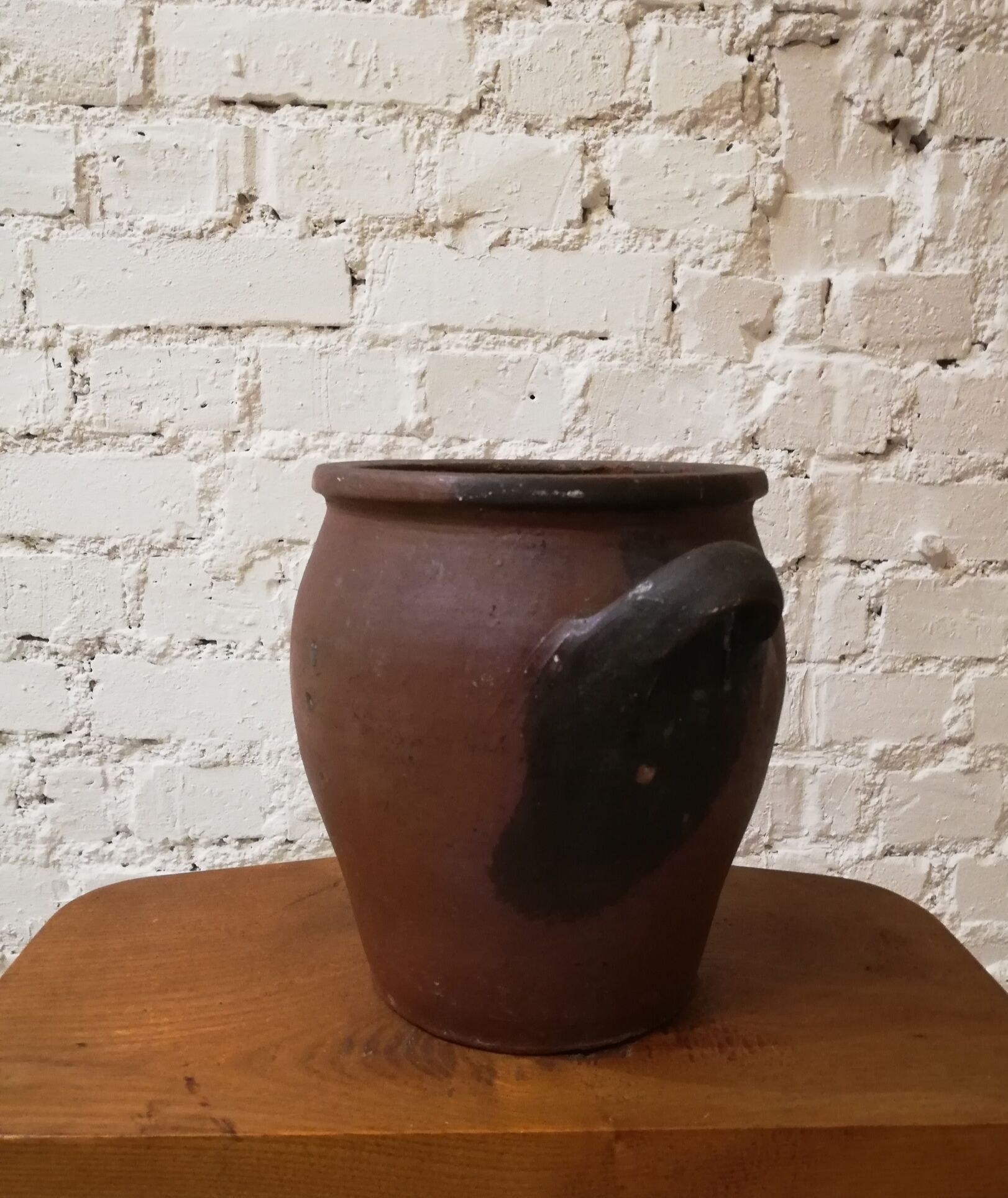 Old red and black terracotta grease pot