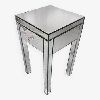 Bedside table covered with beveled mirrors on all sides