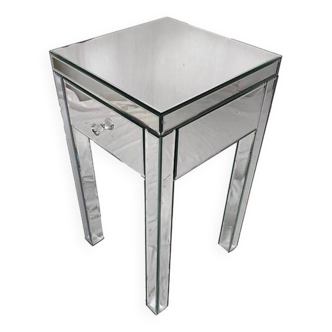 Bedside table covered with beveled mirrors on all sides