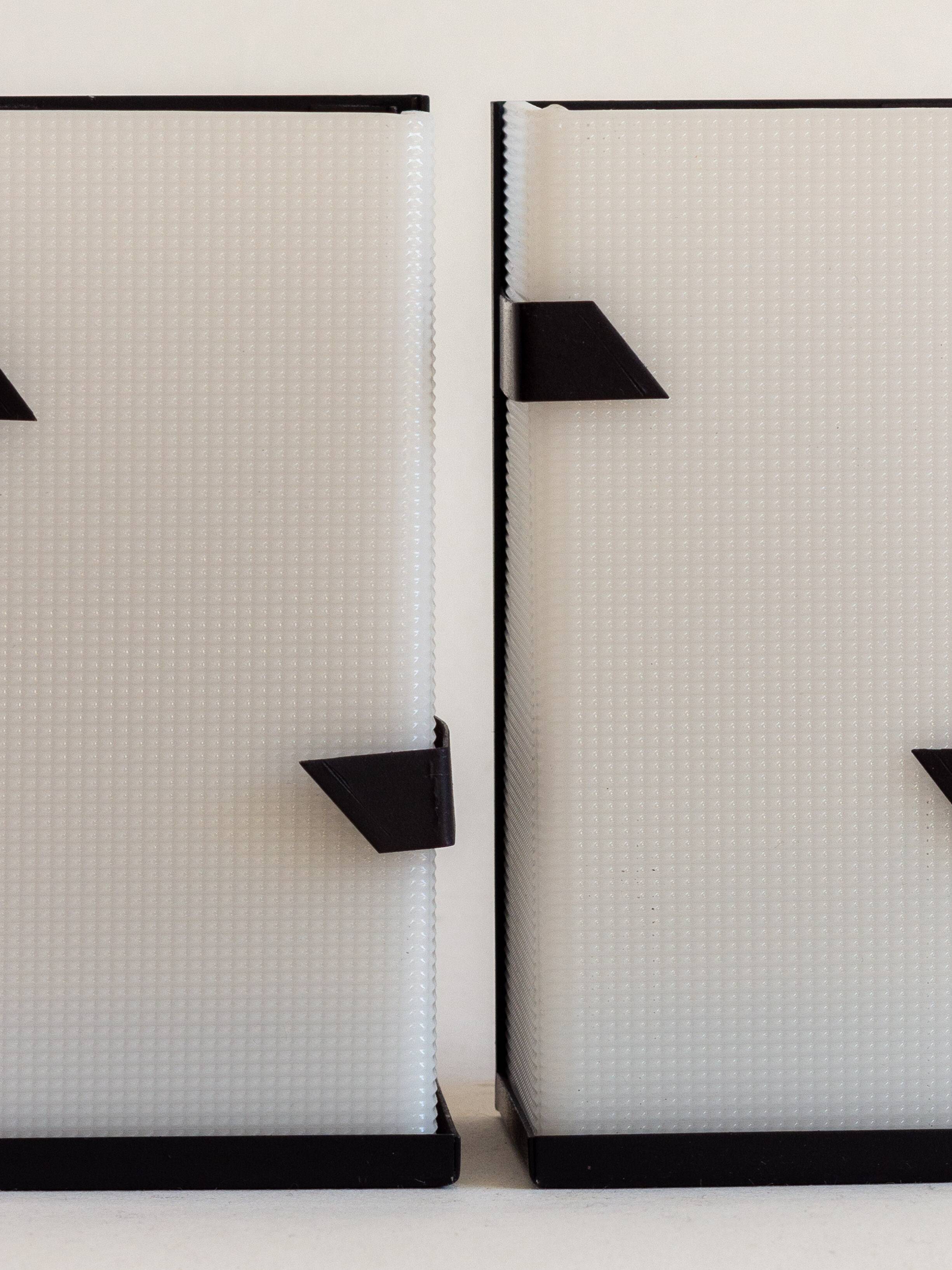 Pair of modernist metal wall lights with perspex diffuser, 1950s/1960s