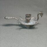 Chiselled brass candlestick in the shape of a peacock.