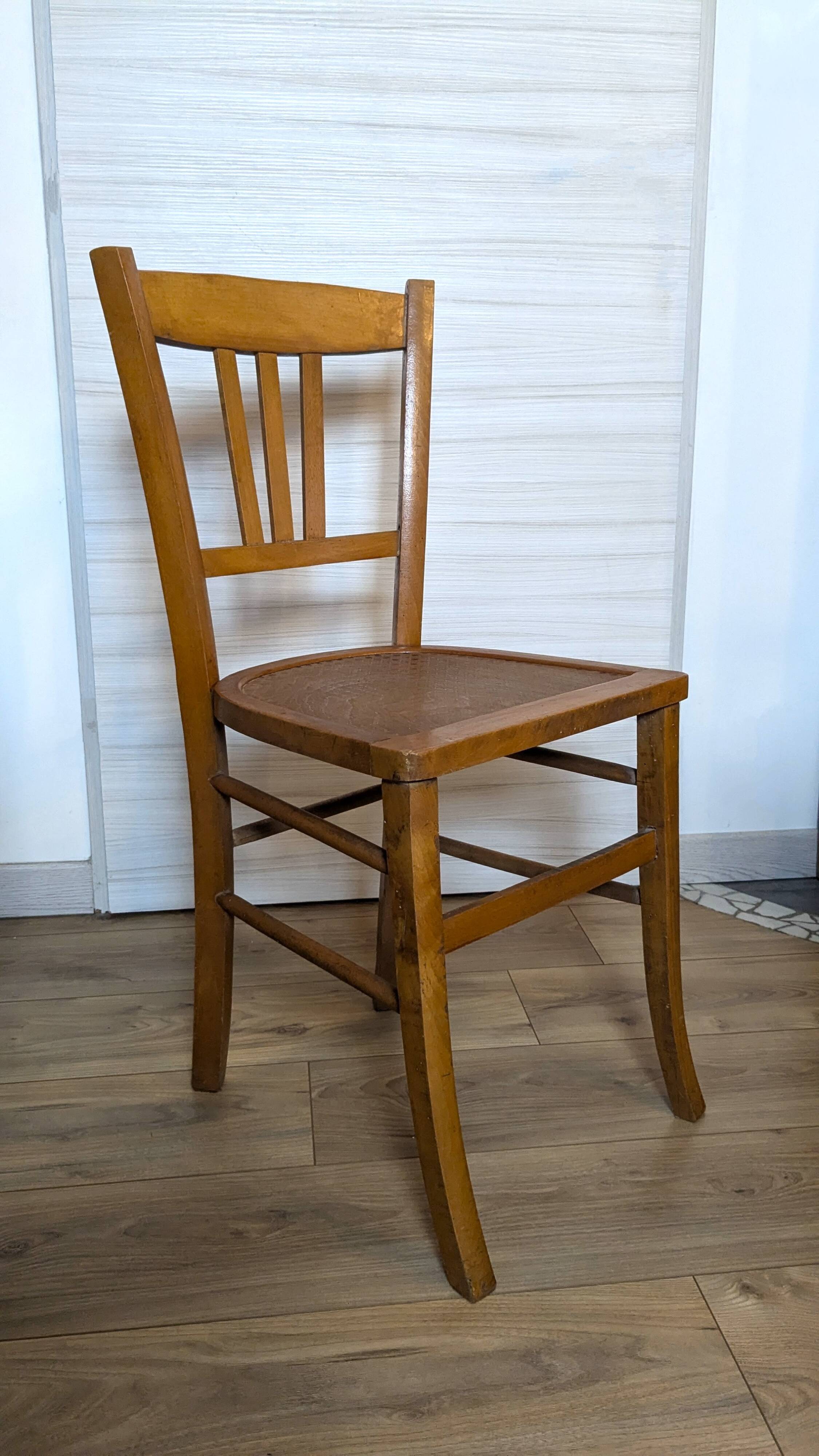 Antique patinated wooden bistro chair from the early 20th century.