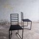 Set of 4 minimalist black steel dining chairs.