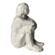 White ceramic seated sculpture