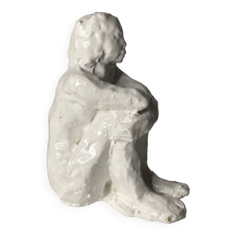 White ceramic seated sculpture