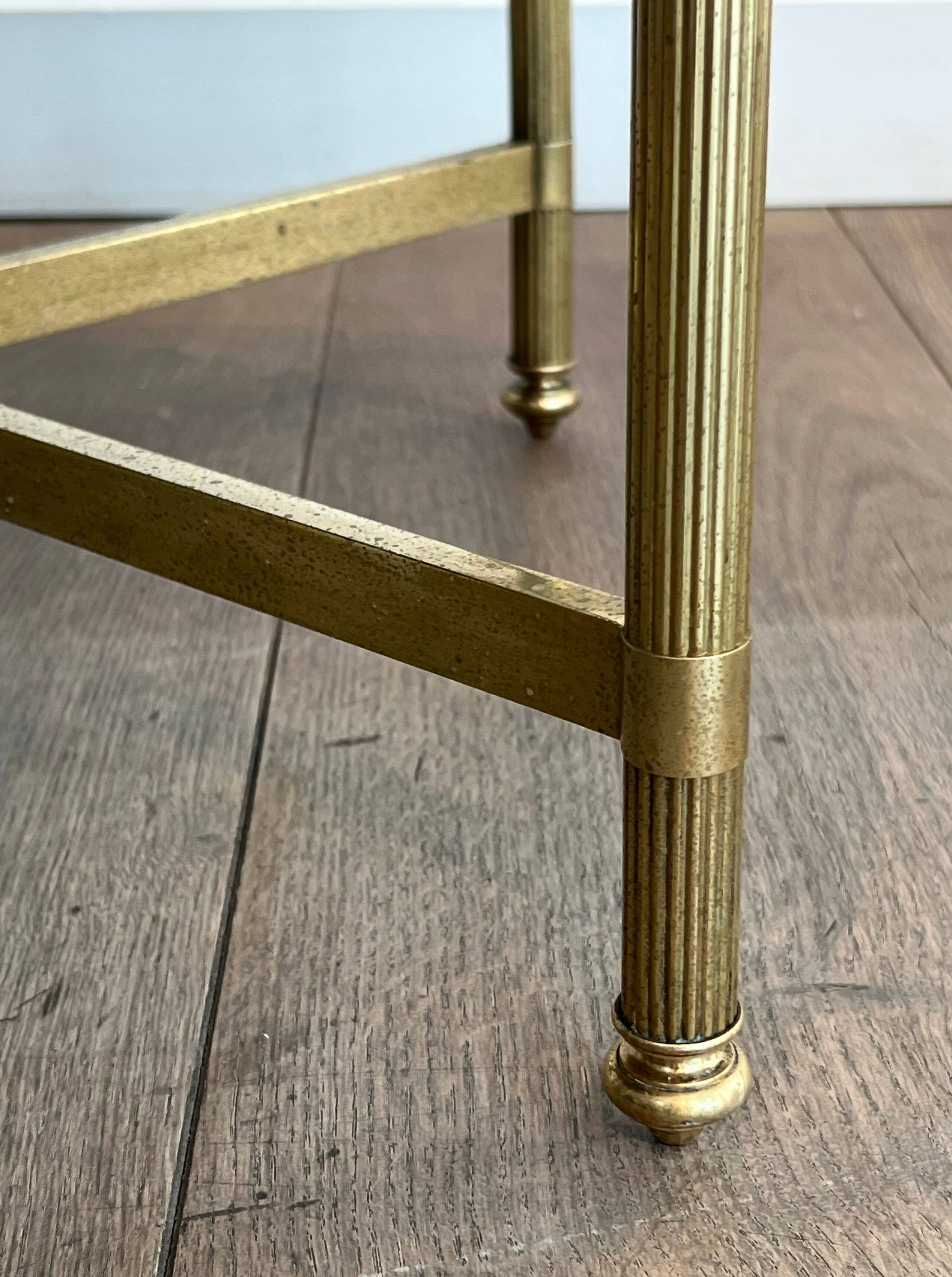 Brass coffee table with a vintage mirror top from the Baguès house.