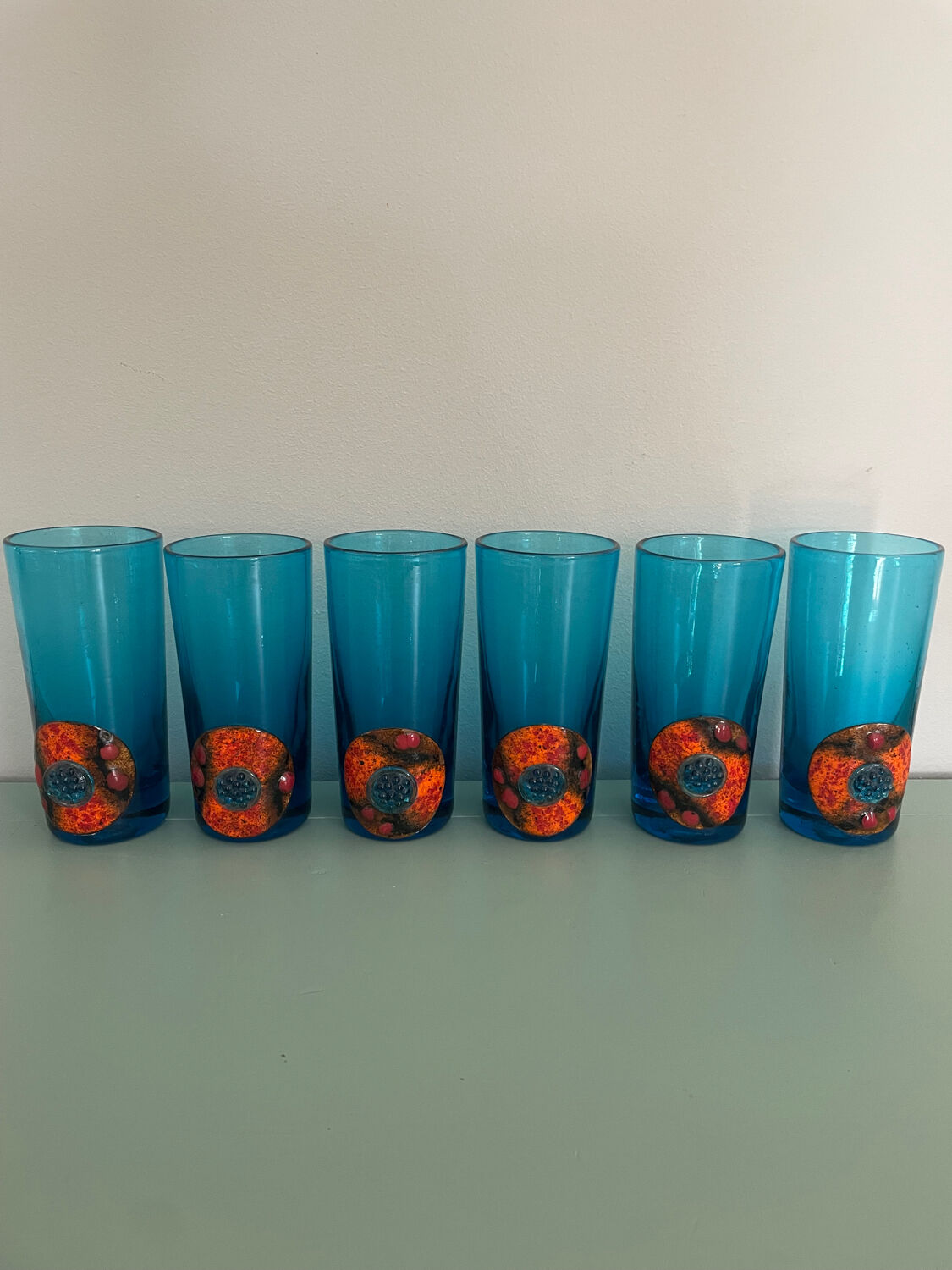 Six blue blown glass and enamel on copper glasses.