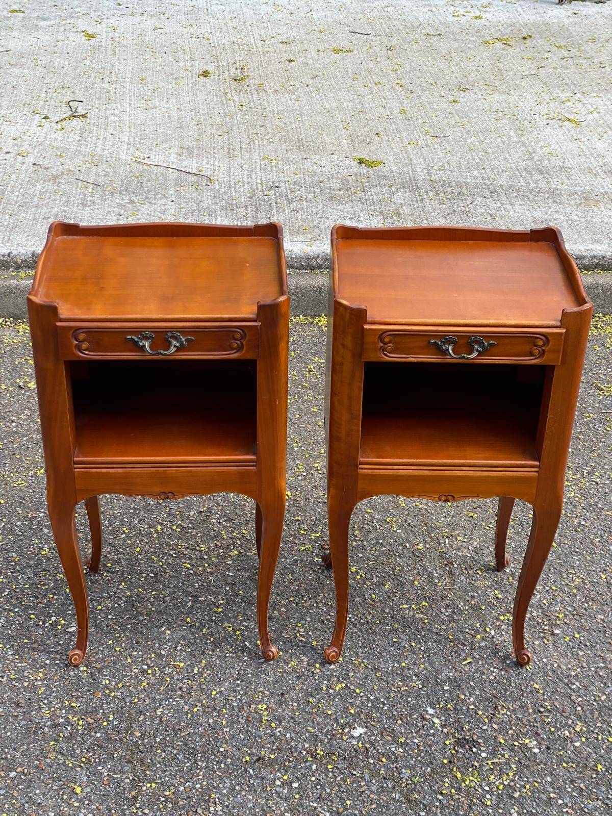 2 Louis XV bedside tables made of curved solid wood with drawers.