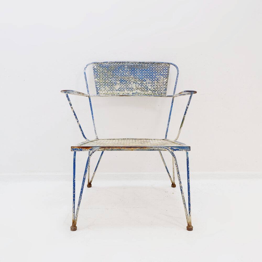 Vintage perforated metal armchair from the 1950s.