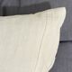 Coussin carré en toile ancienne style kilim tissé, patché, monogramme AB