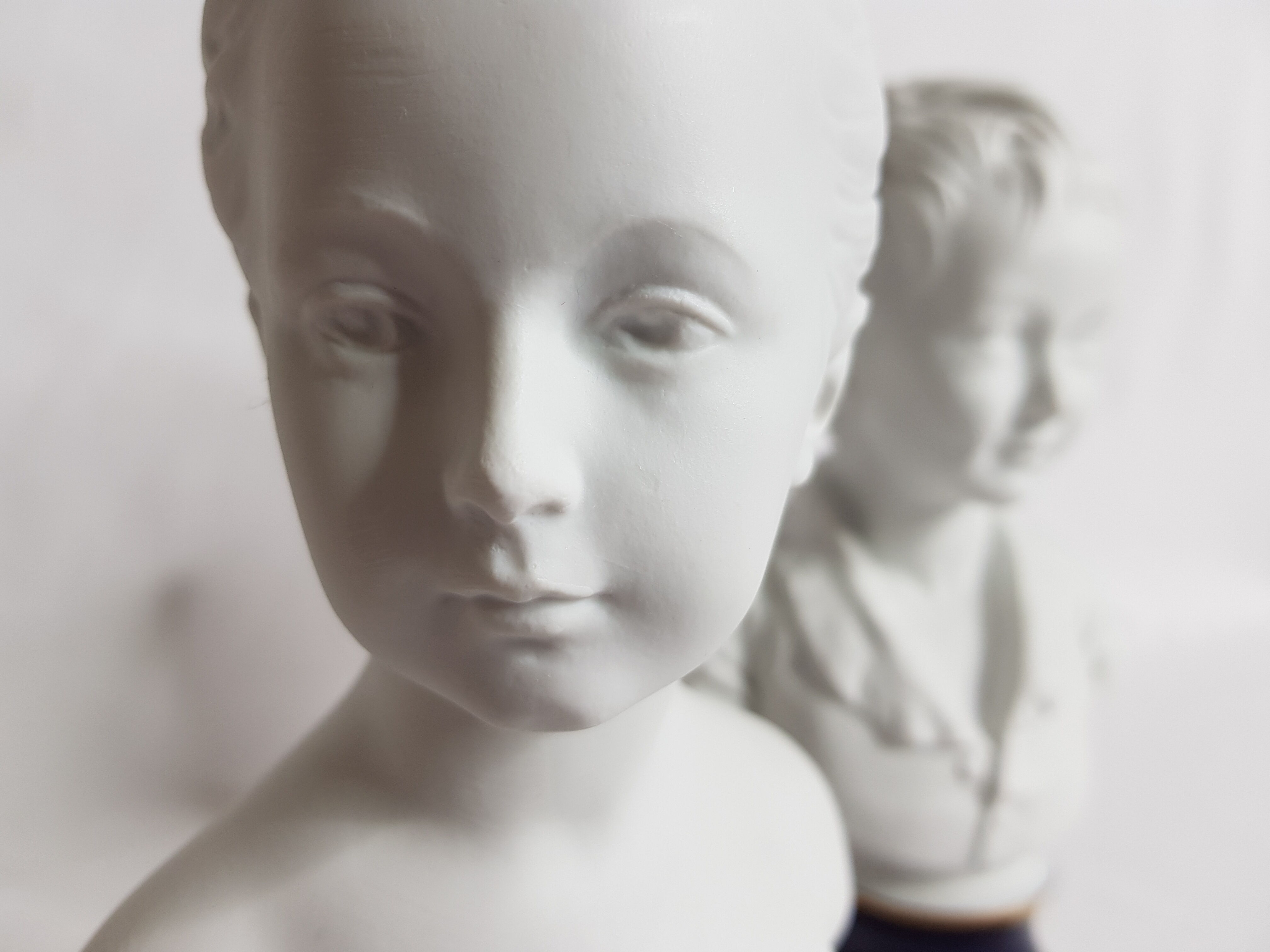 Porcelain biscuit busts by Camille Tharaud, children Louise and Alexandre Brongniart after Houdon