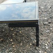 Vintage metal coffee table with glass top.