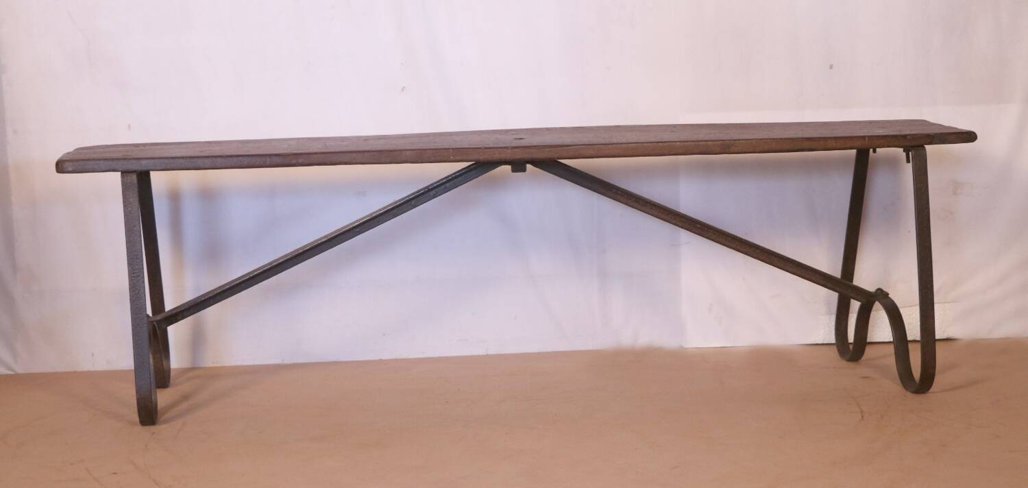 Old bench in Burmese teak with a wrought iron base.