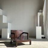 Small low armchair in varnished brown wood