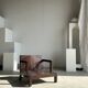 Small low armchair in varnished brown wood