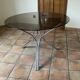 Tripod table Roche Bobois. 1970. Chrome and smoked glass.