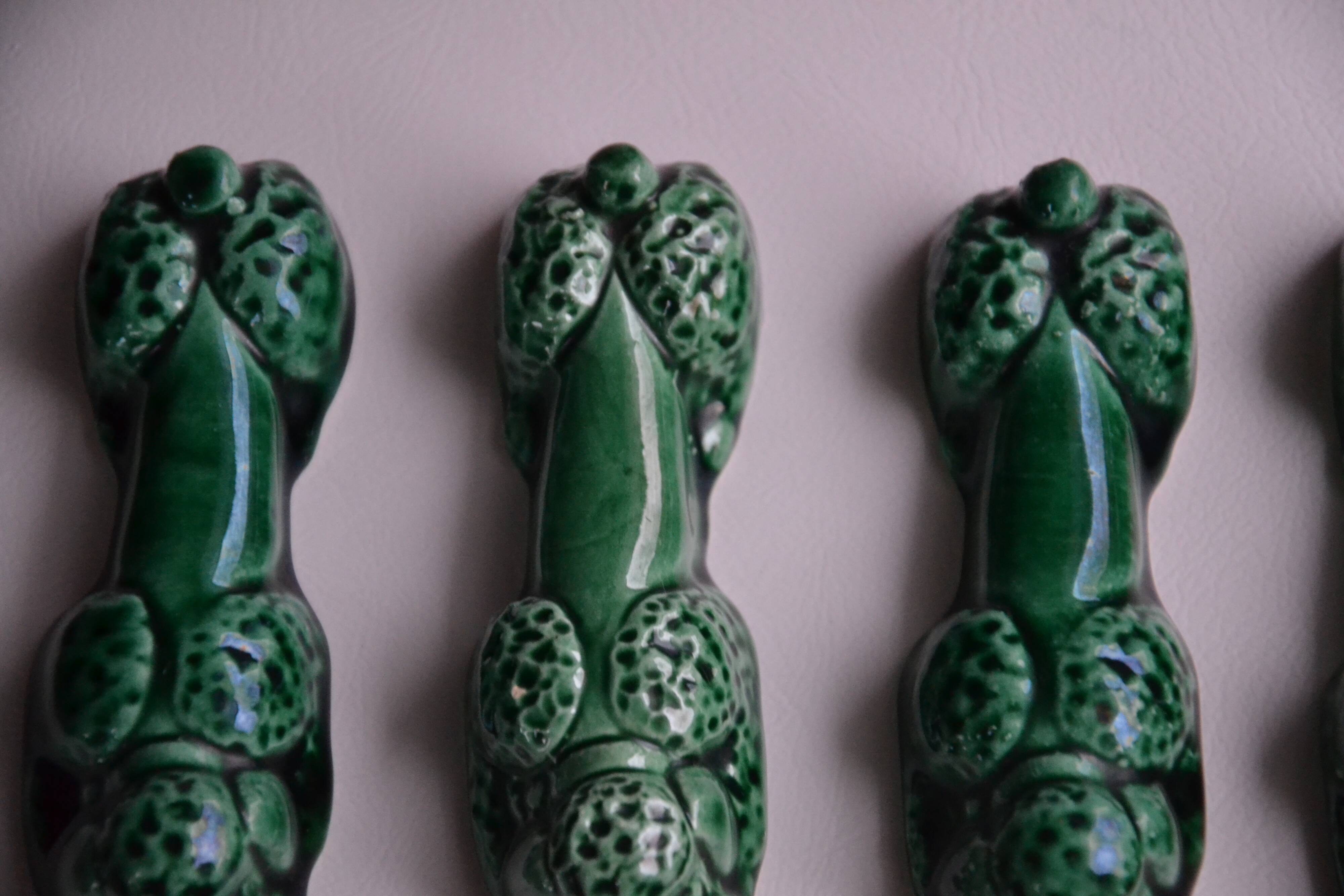 12 green earthenware knife rests