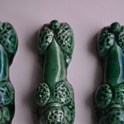 12 green earthenware knife rests