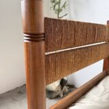 Brutalist style bed with chain and straw