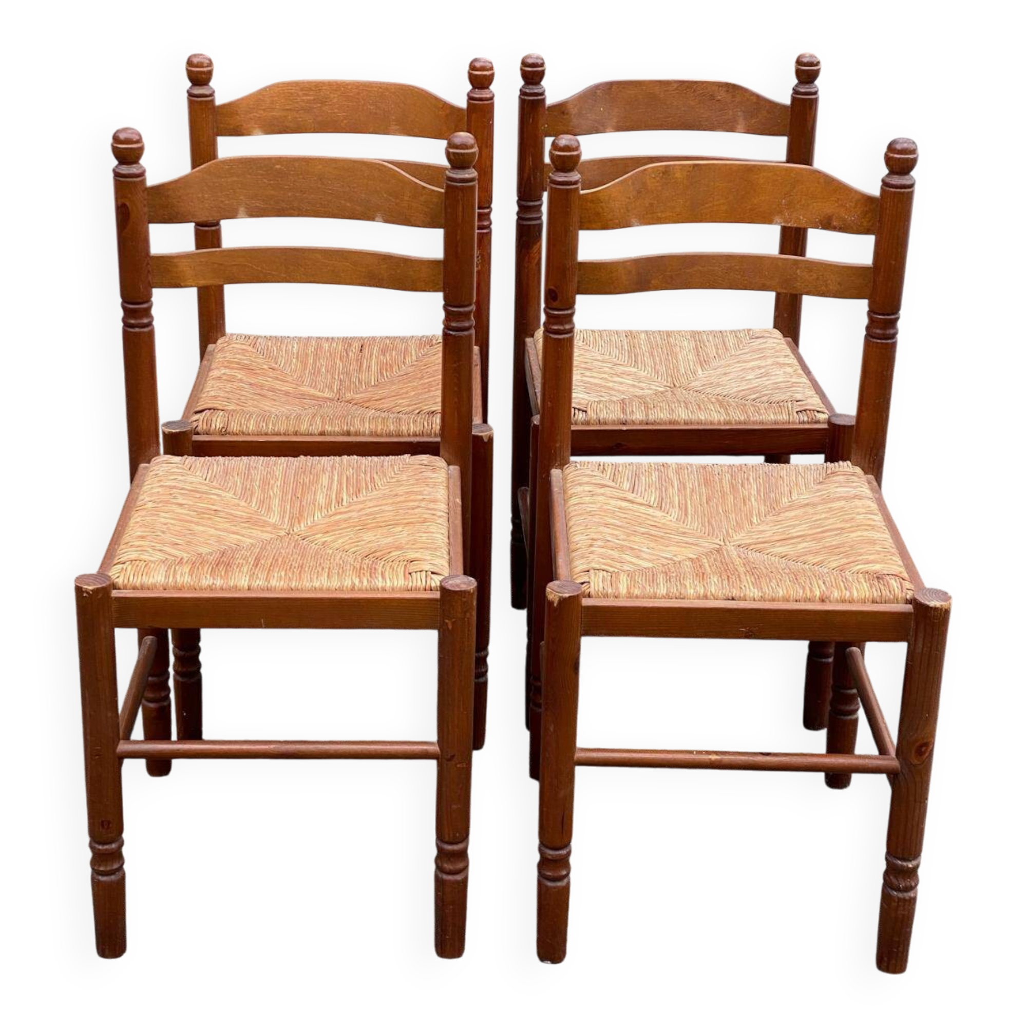 4 dining or kitchen chairs made of solid wood with rush seats.