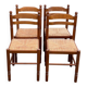 4 dining or kitchen chairs made of solid wood with rush seats.
