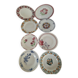 Set of 8 ironstone plates with coordinated designs.