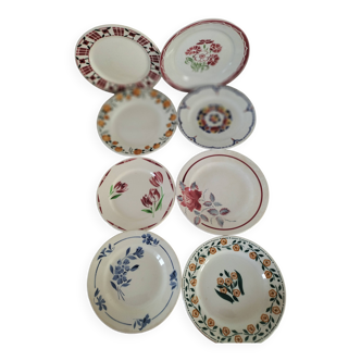 Set of 8 ironstone plates with coordinated designs.