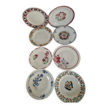 Ensemble de 8 assiettes en terre de fer, aux décors coordonnés
