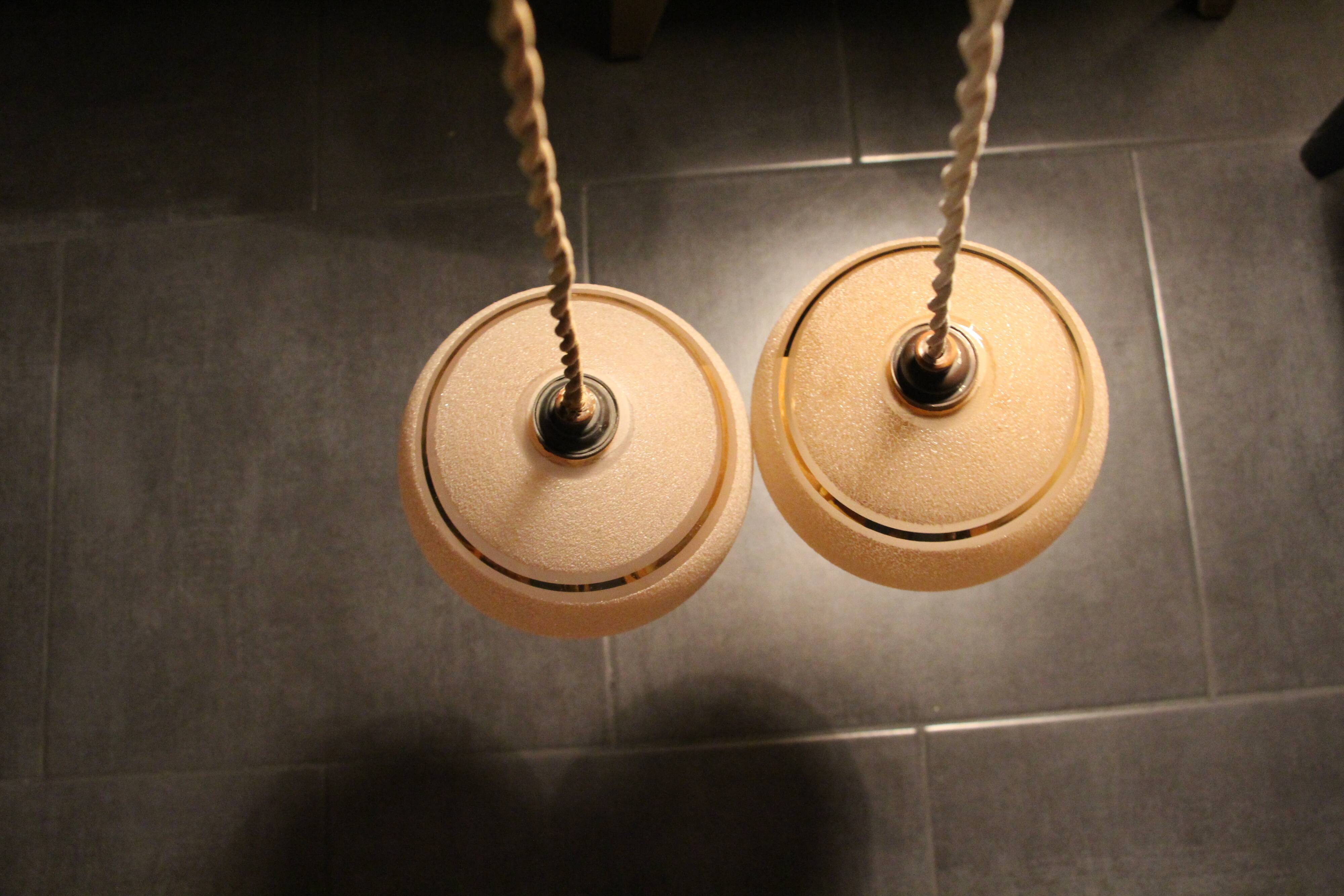 Set of two Art Deco pendant lamps in pink and gold glass