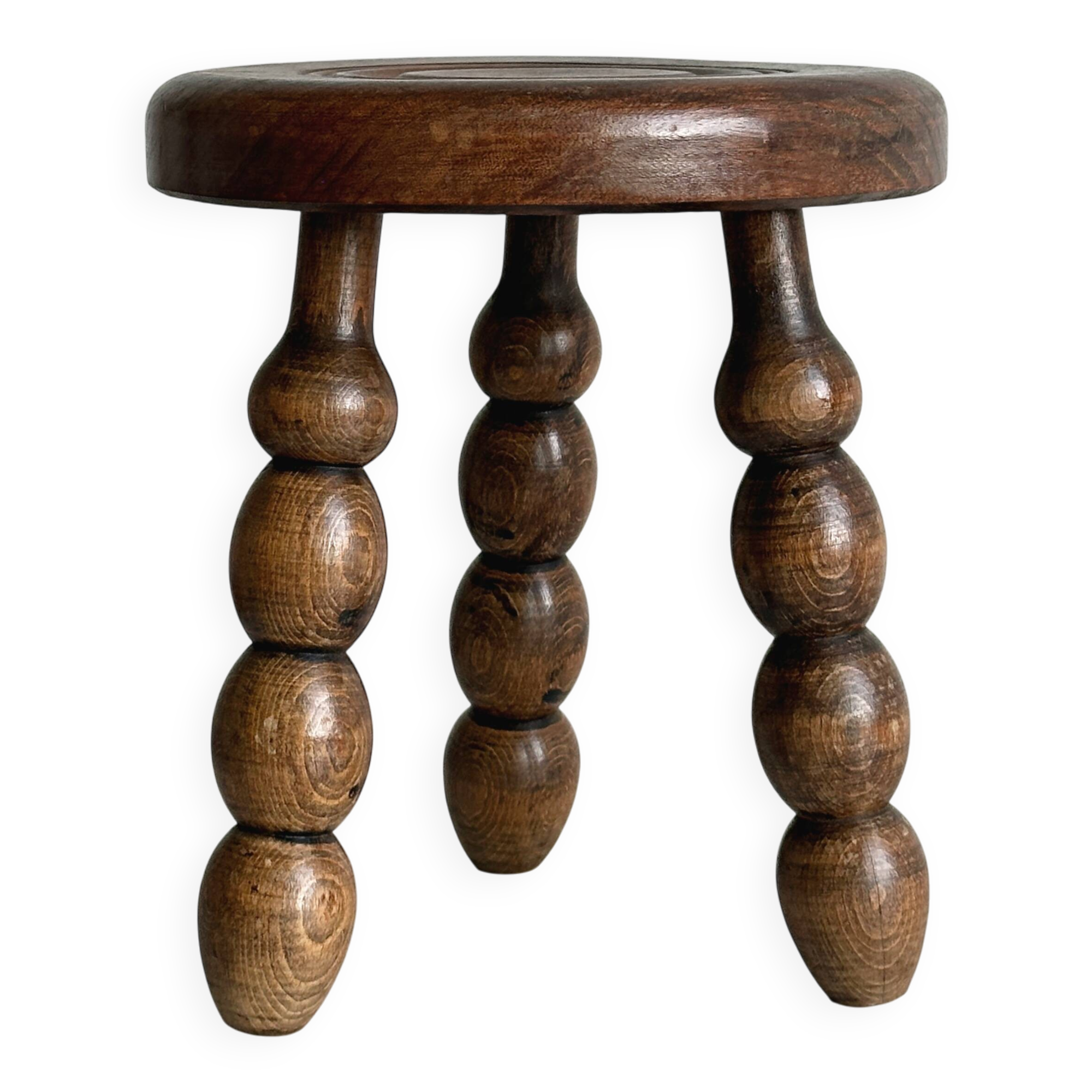Small three-legged stool made of turned wood.