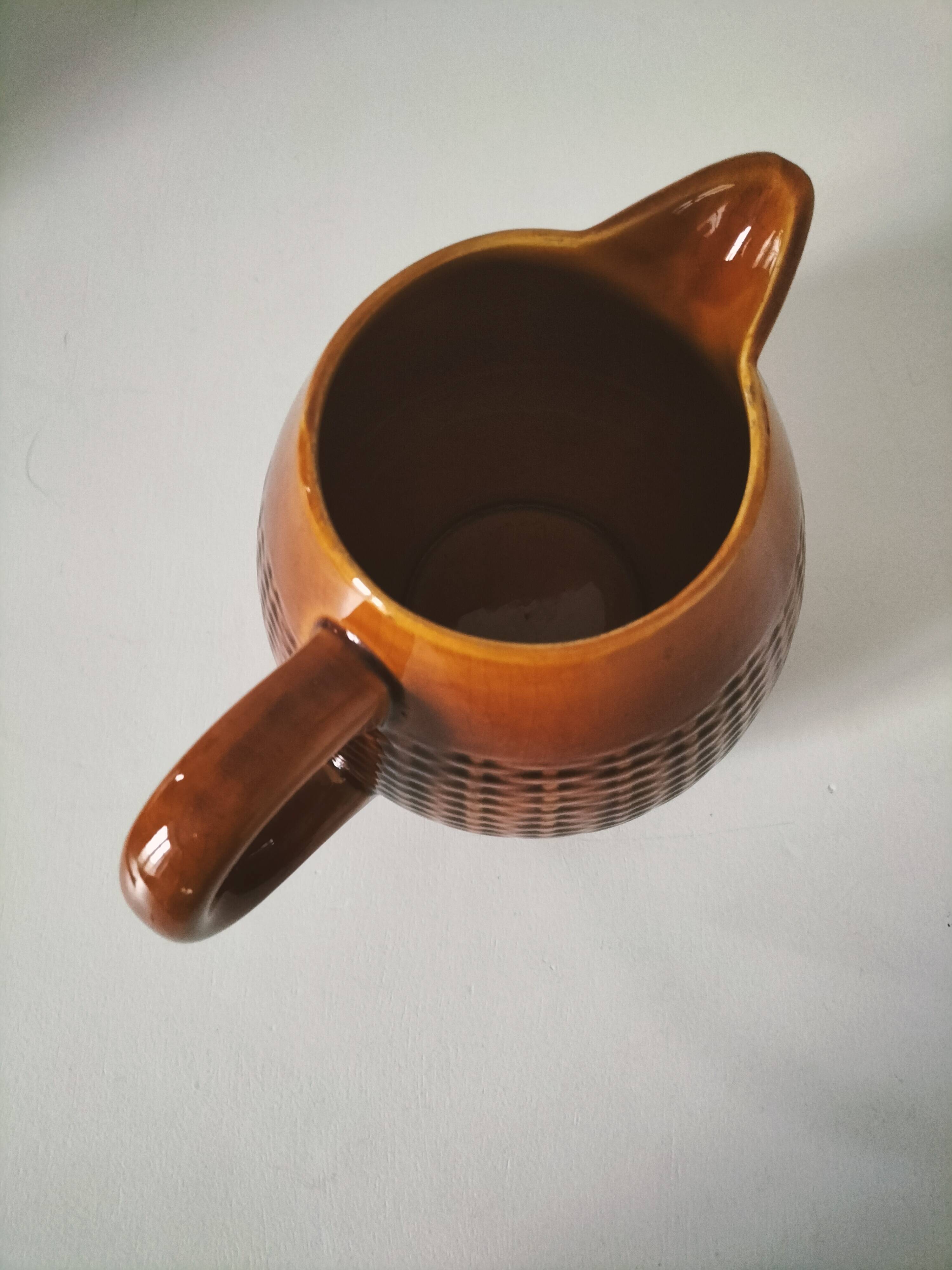 Caramel slipware pitcher with braided relief