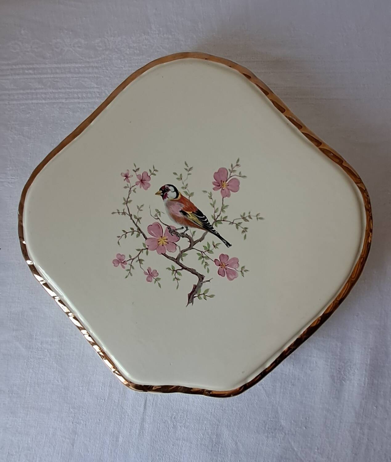 Trivet and bottle holder Salin, 1950s. Bird on branch.