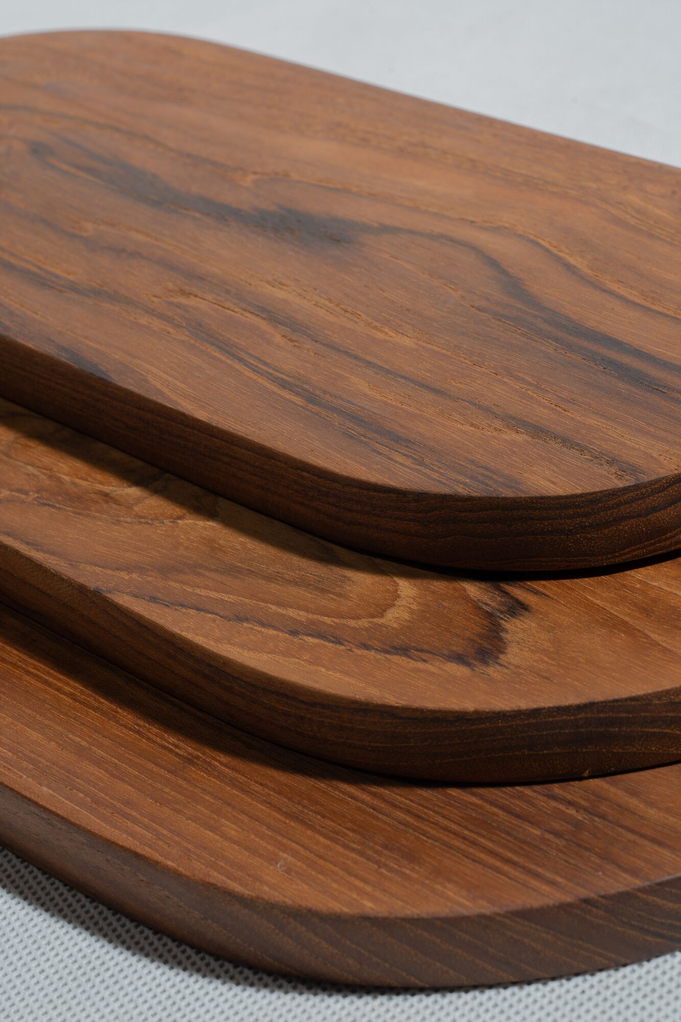 Trio of oval teak trays or cups