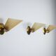 Set of three brass sconces with decorated yellow glass shades