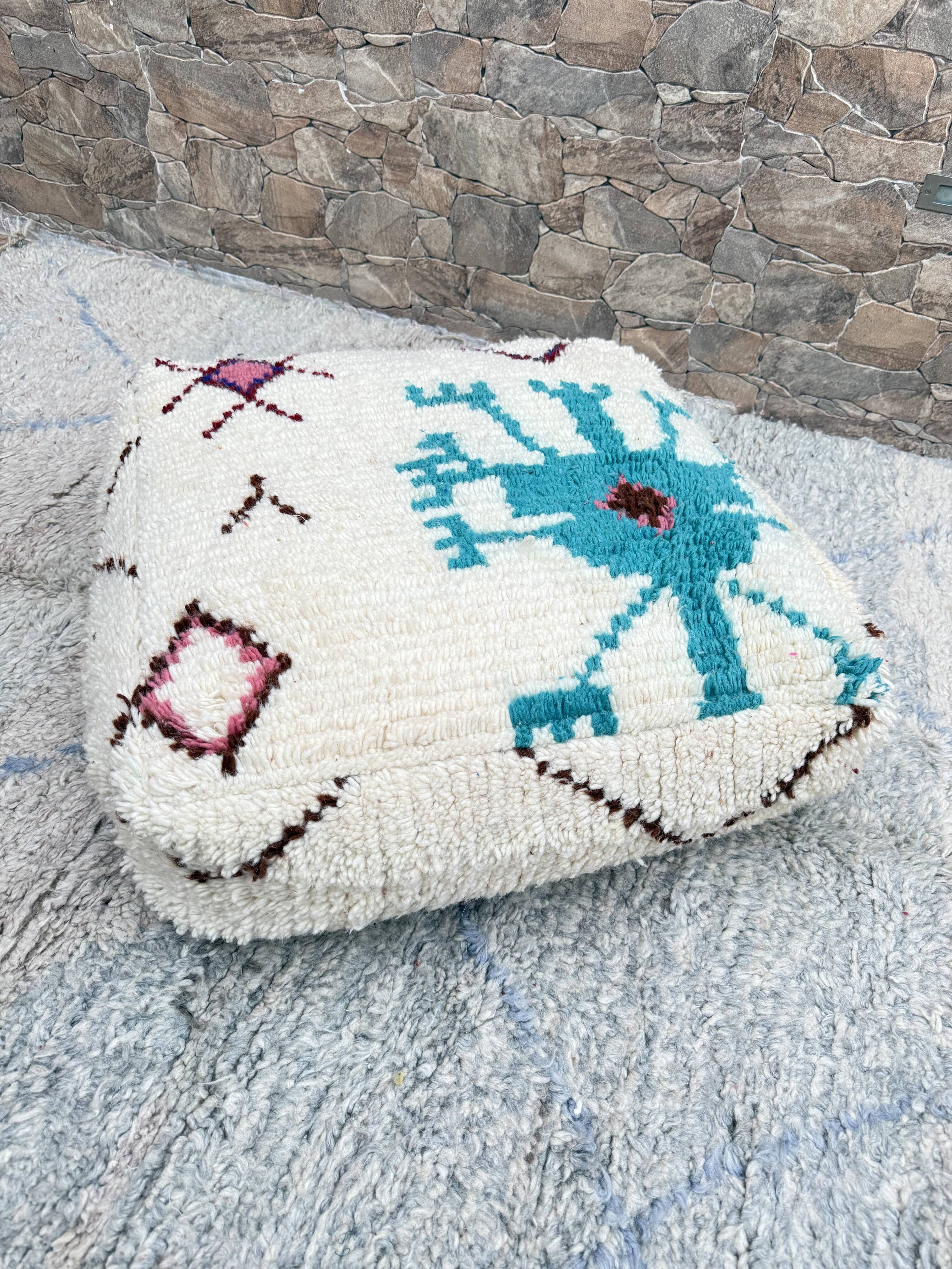 Berber floor pouf: Handwoven Moroccan wool cushion.