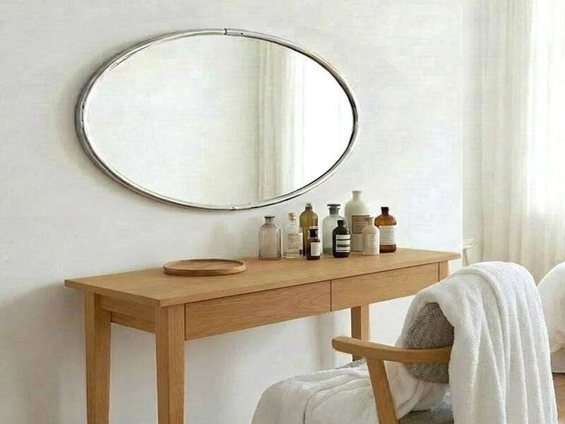 Oval Art Deco mirror with vintage chrome frame from the 1970s.