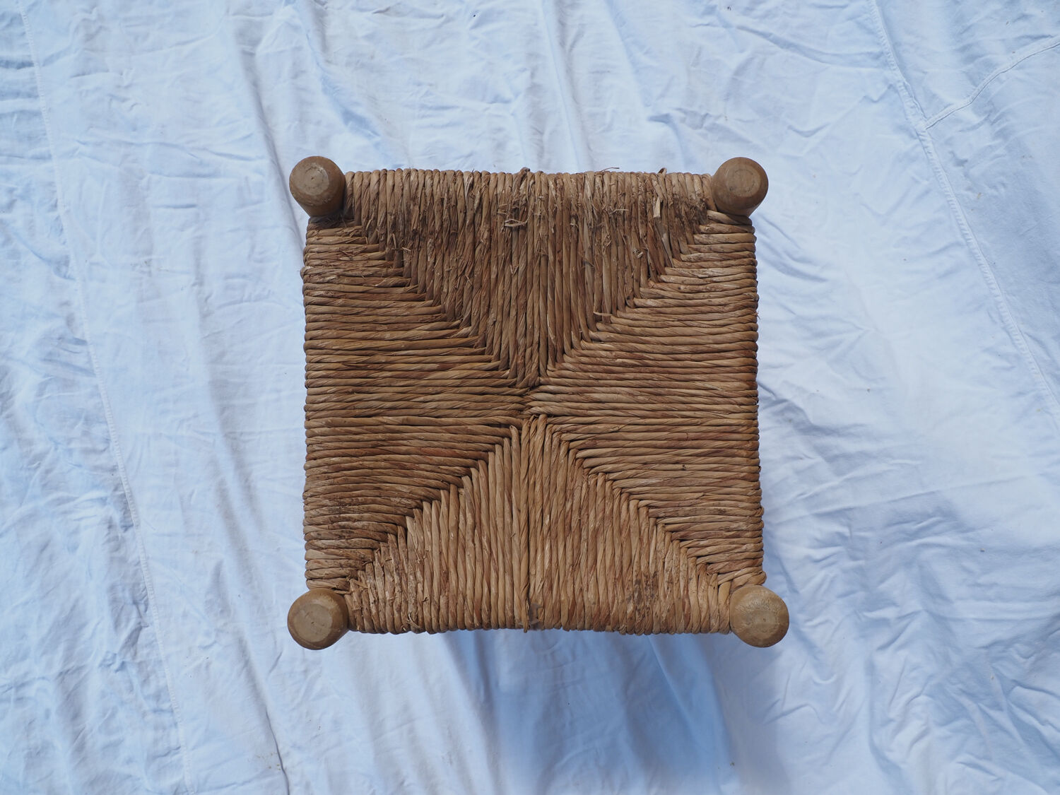 Farm stool made of wood and straw