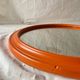 Vintage round wall mirror in orange painted wood - diameter: 48 cm