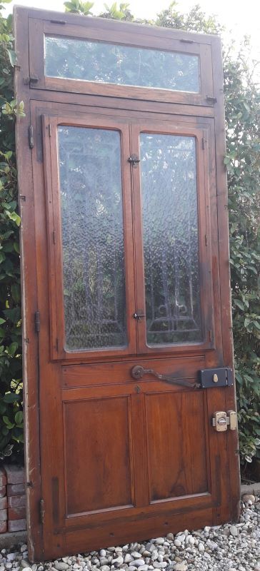 Oak entrance door and its frame and transom, wrought iron gates