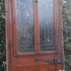Oak entrance door and its frame and transom, wrought iron gates