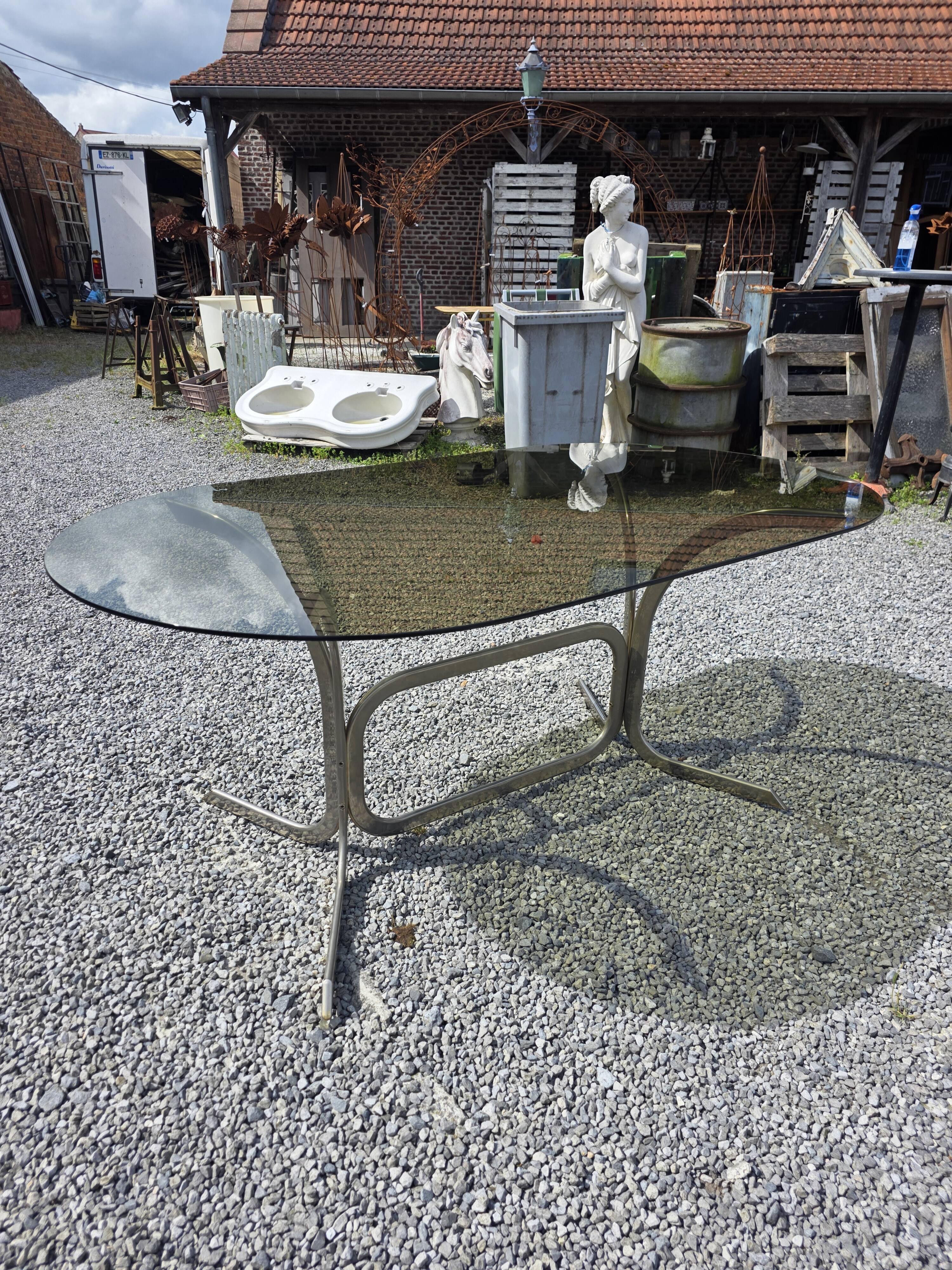 Silver metal table with smoked glass top from the 1970s.