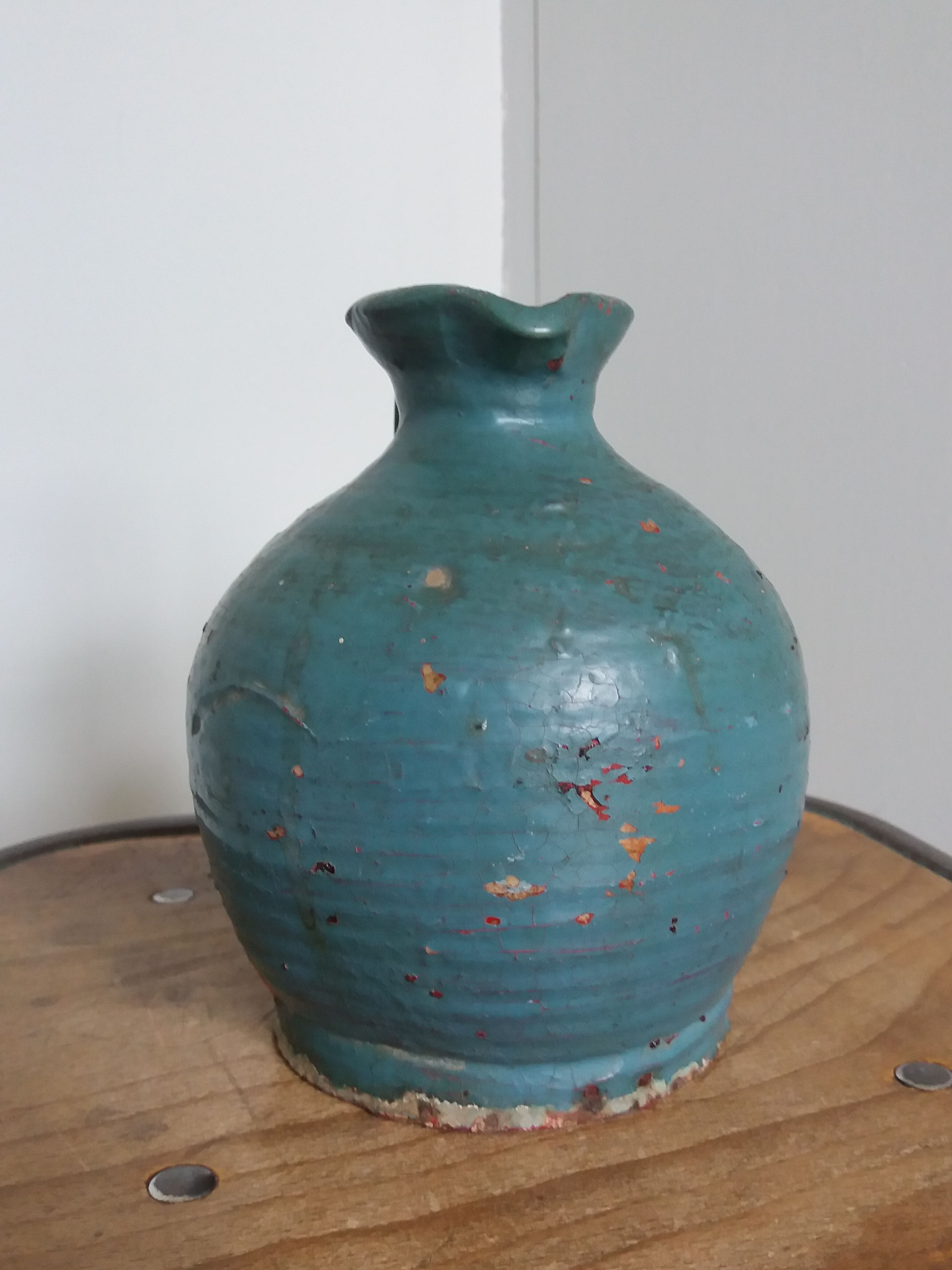 Sandstone pitcher painted in turquoise, very old pottery