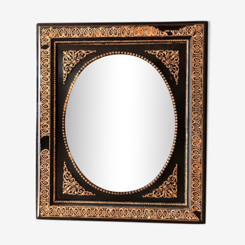 Black and gilded ebonite frame, wood and plaster 19th century