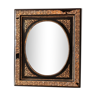 Black and gilded ebonite frame, wood and plaster 19th century