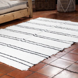 Simple carpet in ecru recycled cotton with black stripes of Berber type