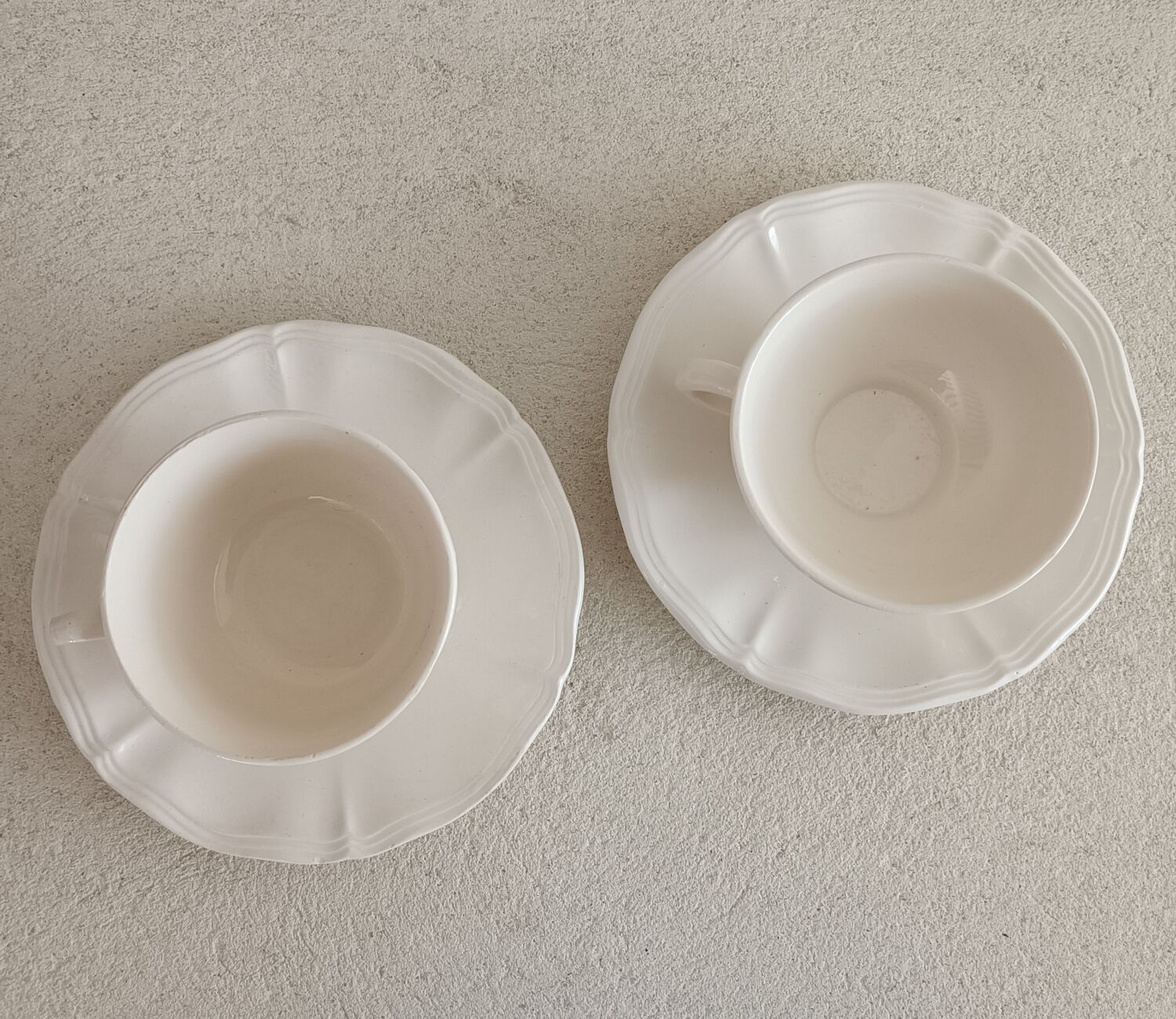 Two ivory cups and saucers from Sarreguemines