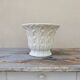 Important white earthenware pot cache with leafy decoration