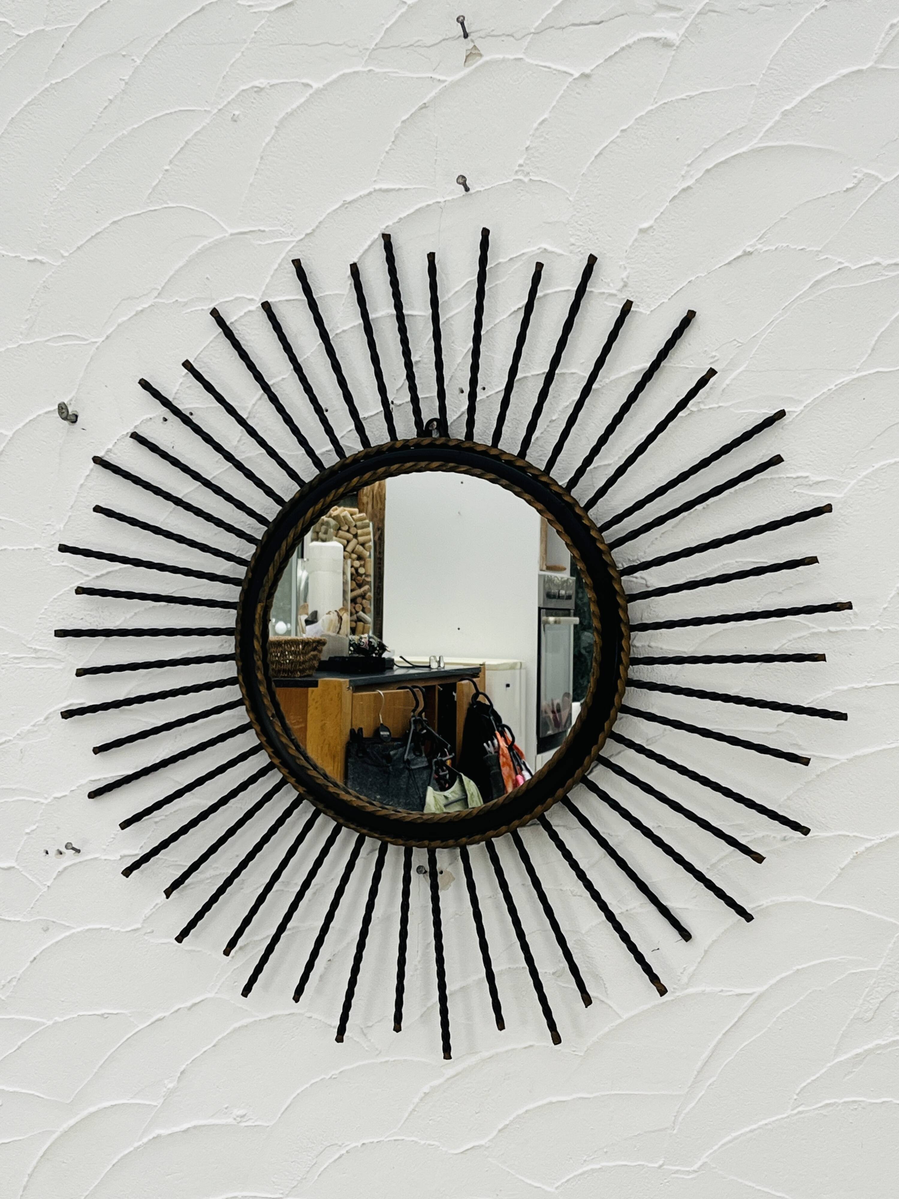 Vintage black and gold metal sun mirror from the 1960s.